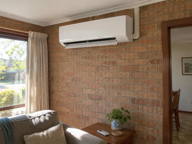 Clean split system indoor unit running on a brick living room wall in Gilles Plains